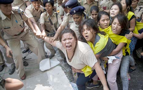 Policewomen detain Tibetan youth activists during a protest to highlight Chinese control over Tibet, outside the Hyderabad House in New Delhi.