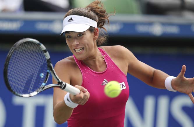 Garbine Muguruza of Spain returns a shot against Jelena Jankovic of Serbia during their second round match of the Pan Pacific Open Tennis tournament in Tokyo on Thursday.