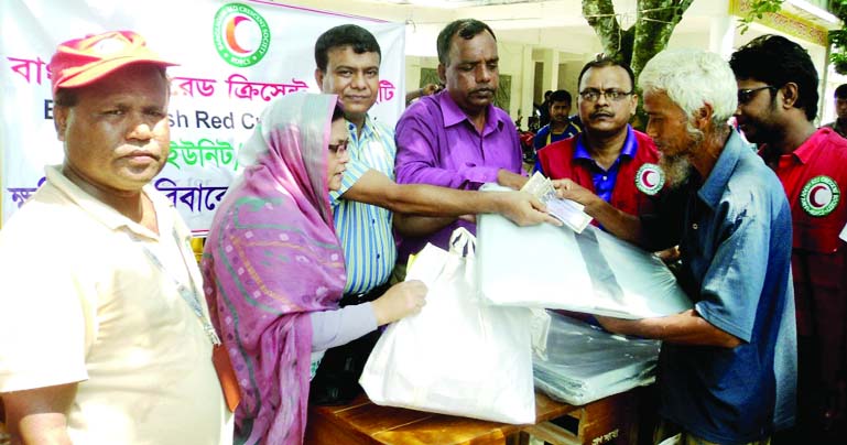 RANGPUR: Gangachara UNO Tauhidur Rahman distributing cash money and relief goods of Bangladesh Red Crescent Society at a ceremony in Gangachara upazila on Thursday.