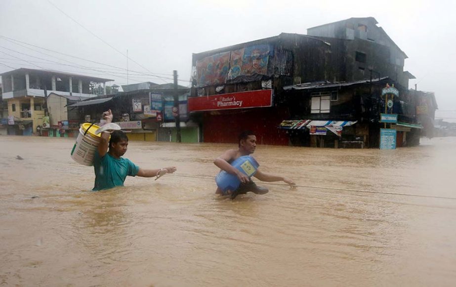 Residents make their way through deep floodwaters after heavy monsoon rains spawned by tropical storm Fung-Wong flooded Marikina city, east of Manila.