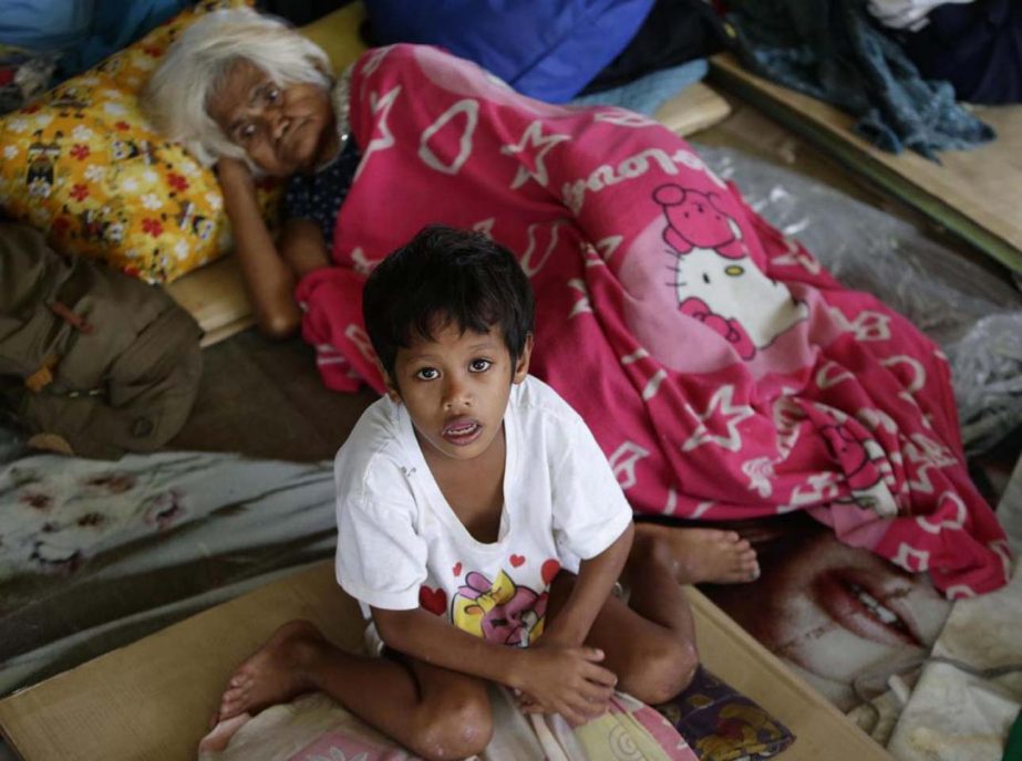 Residents take a rest in an evacuation center on Saturday in Marikina city east of Manila, Philippines.