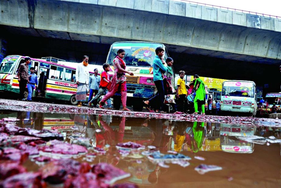 As stagnant rain waters created potholes and cracks on the open space along Sayedabad Flyover, vehicles were plying haphazardly causing immense sufferings to commuters. This photo was taken on Sunday.