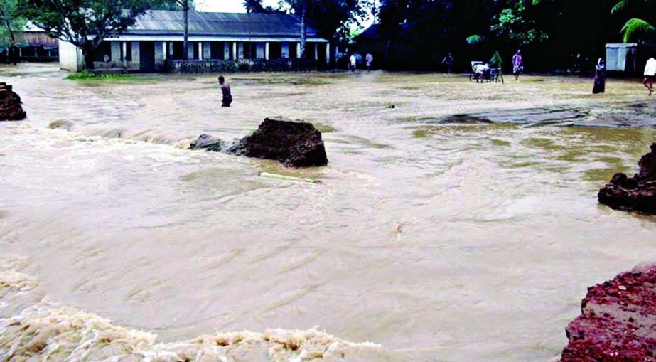 Hilly-waters from upstream flooded 31 villages of five unions of Nalitabari UZ in Sherpur district. Photo shows a high school under knee-deep water on Monday.