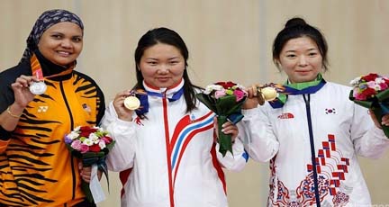 From left, silver medal winner Malaysia's Nur Suryani Binti Mohamed Taibi, gold medal winner Mongolia's Narantuya Chuluunbadrakh and bronze medal winner South Korea's Eum Bitna pose after winning the women's 50m rifle prone shooting finals at the 17th