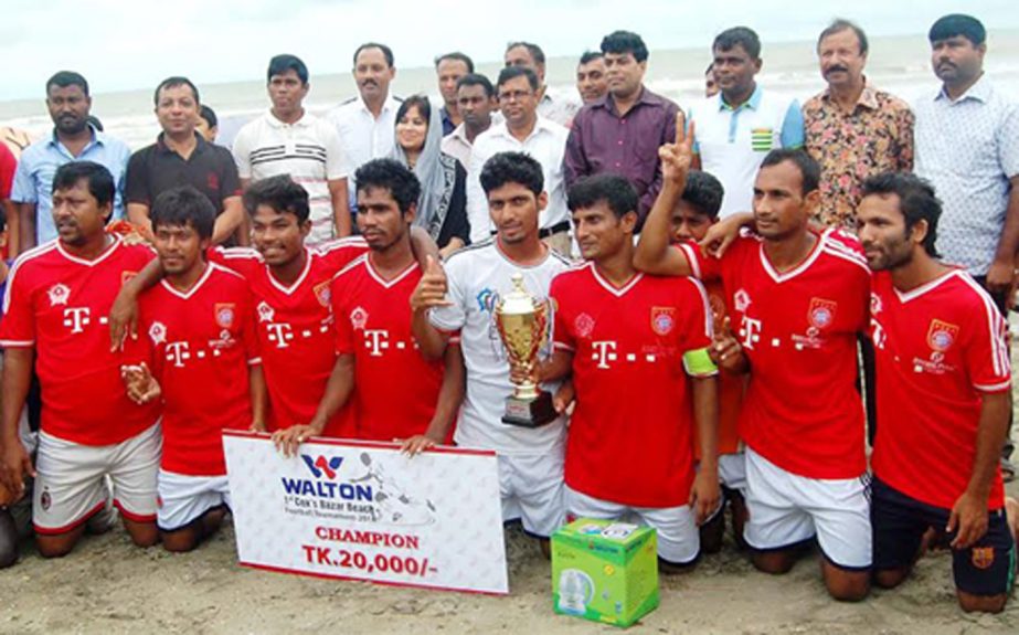Youngmens Club, the champions of the Walton 1st Cox's Bazar Beach Football Tournament with the guests and the officials of Cox's Bazar District Sports Association pose for a photograph at the Laboni Point in the Cox's Bazar Sea Beach on Wednesday.