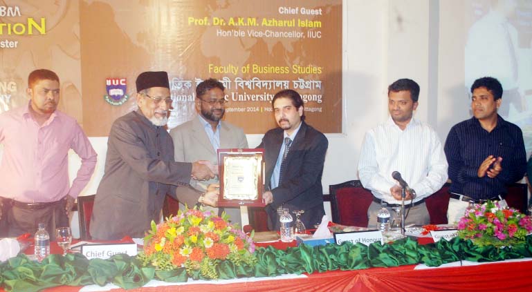 Pro-Vice Chancellor of IIUC Prof. Dr. Abu Bakr Rafique giving Business Enterpreniorship Award-2014 from IIUC to Deputy Managing Director of Hotel Agrabad Ltd ASM Kaisar Ali for his outstanding contribution at a function recently.