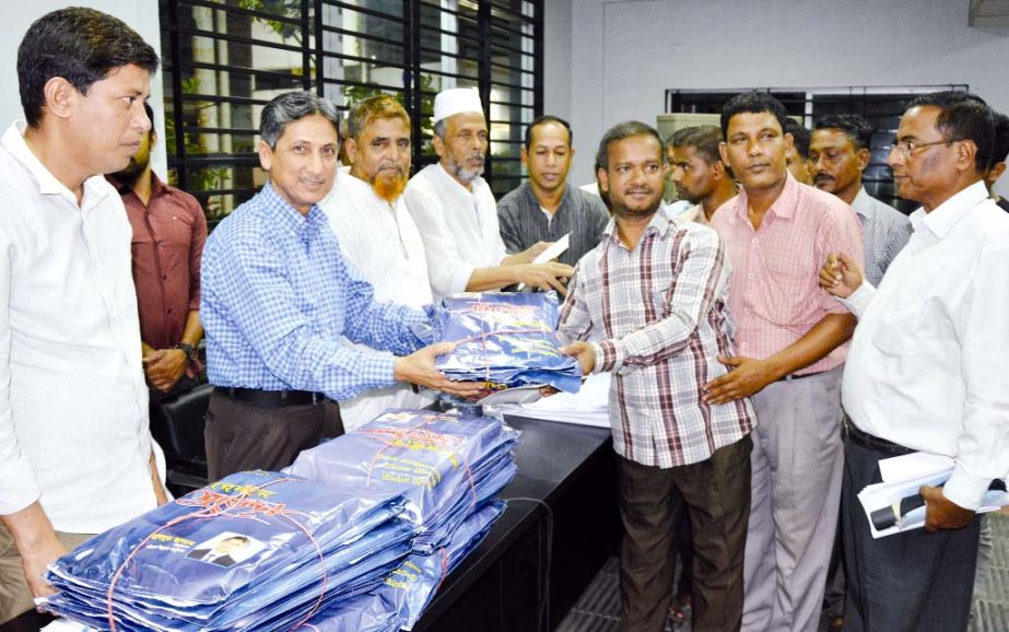 CDA Chairman Abdus Salam distributing clothes in Ward No.2,3,7,9,13 and 37 on the occasion of Durga Puja of Hindu Community recently.
