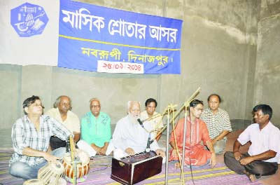 DINAJPUR: Ostad Simud Ali Khan, Principal, Noborupee Cultural organisation rendering classical songs at the monthly programme of the organisation on Thursday.