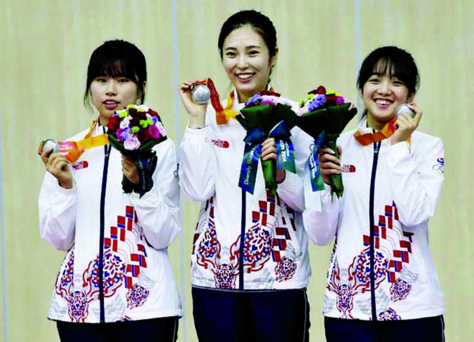 Silver medalist in the women's 50m rifle 3 positions team event, South Korea's from left, Kim Seola, Jeong Mira, and Yoo Seoyoung celebrate on the podium at the 17th Asian Games at Ongnyeon International Shooting Range in Incheon, South Korea on Friday.