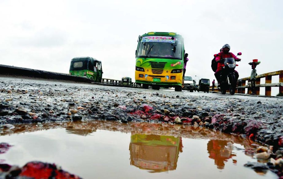 A severe cavity being developed on the entry point of Kanehpur Bridge, where long-route vehicles plying on it, risking their lives. Roads and Highways Deptt's aloofness may occur major accidents anytime. This photo was taken on Saturday.