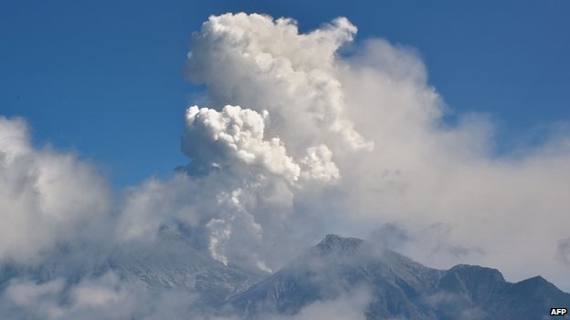 The eruption continued under clear blue skies on Sunday