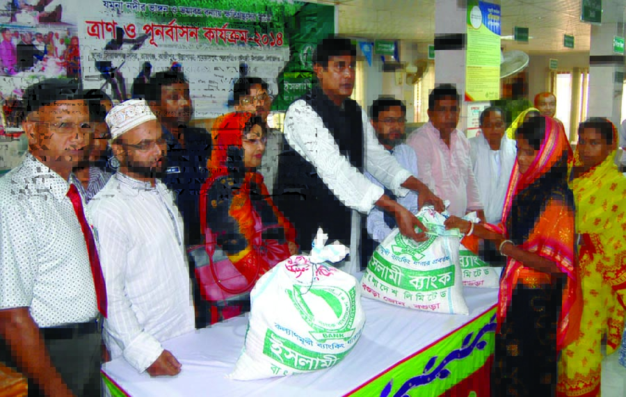 Islami Bank Bangladesh Limited Bogra Zone distributing relief among flood affected people of Ullahpara, Sirajganj recently.