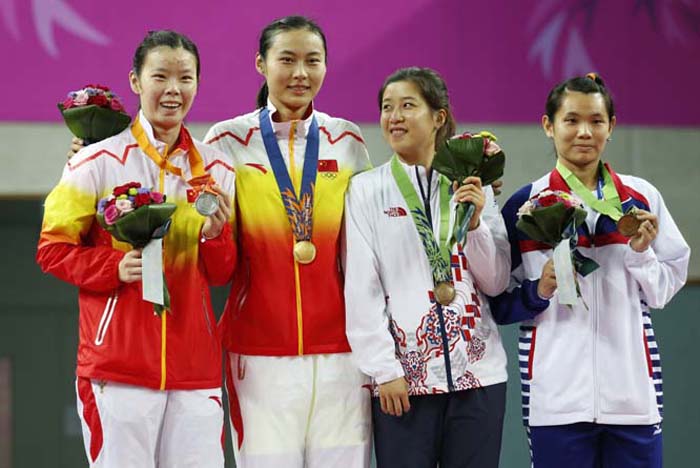 From left, silver medal winner China's Li Xuerui, gold medal winner China's Wang Yihan, bronze medal winners South Koreaâ€™s Bae Yeonju and Taiwan's Tai Tzu Ying celebrate after winning the women's singles badminton match at the 17th Asian Games