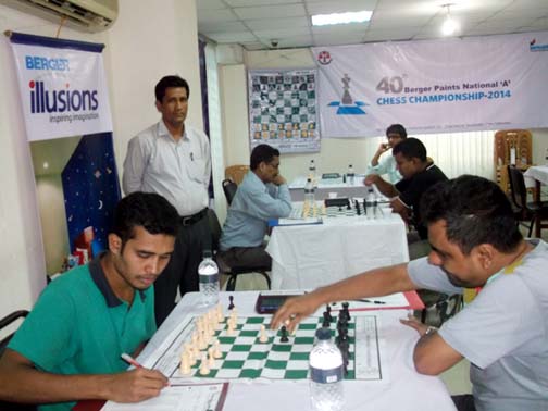 GM Ziaur Rahman (right) moves a pawn against Masum Hossain during their match of the Berger Paints National A Chess Championship at the Media Centre of Bangladesh Olympic Association Bhaban on Monday.