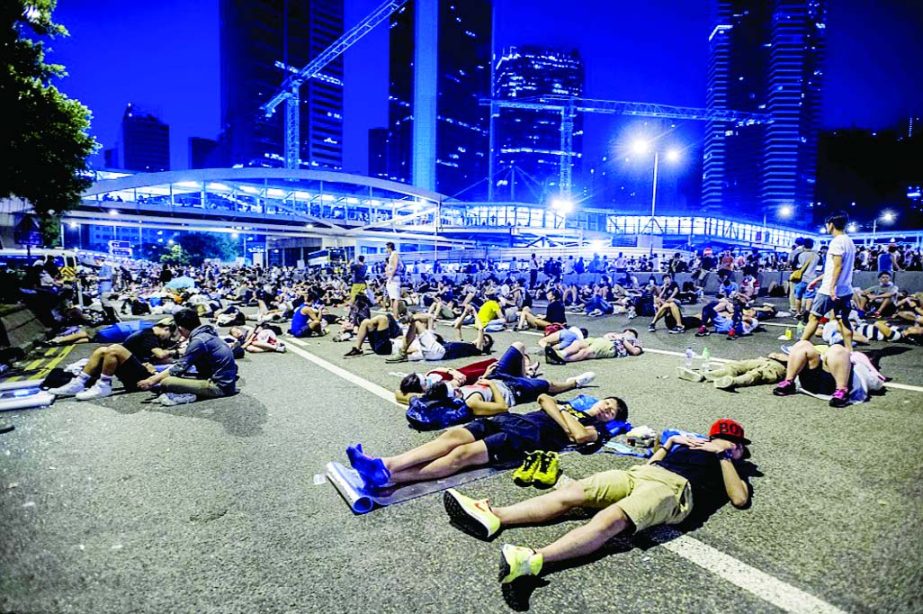 Protesters rest following pro-democracy protests in Hong Kong. China has called the protests illegal and endorsed the Hong Kong government's crackdown.