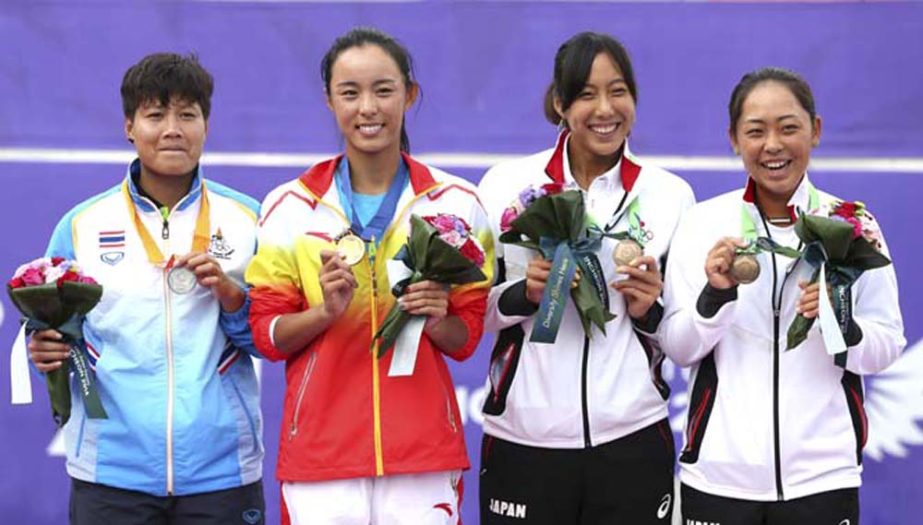 Medal winners from left : Thailand's Luksika Kumkhum silver, China's Wang Qiang gold, and Japan's Eri Hozumi, Misa Eguchi, bronze pose for photos after the women's tennis final at the 17th Asian Games in Incheon, South Korea on Tuesday.
