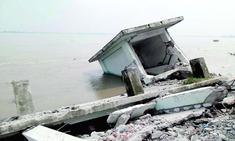 A two-storied building of Angaridah Govt Primary School being devoured by erosion of embankment in Brahmaputra river at Fulchhari point of Gaibandha district. This photo was taken on Monday.