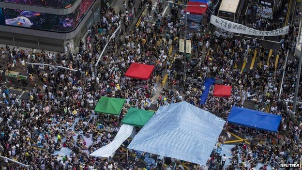 Protests spread to a major shopping district popular with visitors from mainland China on Wednesday