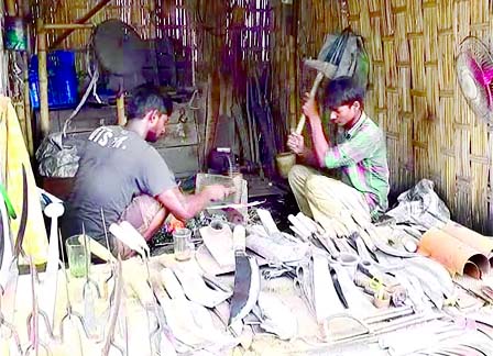 KURIGRAM: Blacksmiths in Kurigram are working in their shop.