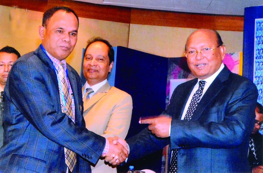 Commerce Minister Tofail Ahmed handing over CIP Card to Md Kamal Uddin, Managing Director of Diganta Sweaters Ltd, for his contributions in export business of the country at a city hotel on Wednesday.