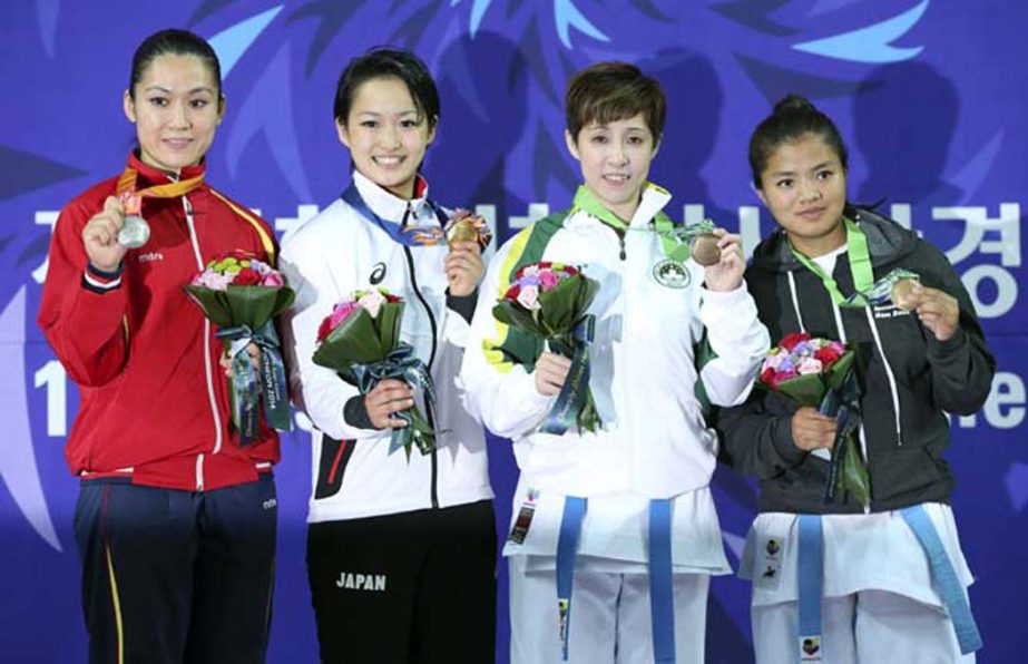 From left: Silver medalist Nguyen Hoang Ngan of Vietnam, gold medalist Kiyou Shimizu of Japan, bronze medalists Cheung Pui Si of Macao, and Bimala Tamang of Nepal pose for photographers during the award ceremony of women's Kata contest of Karate at the 1