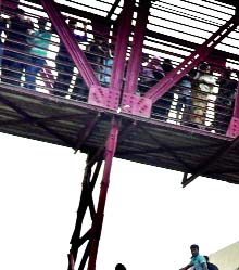 Mad rush : Desperate home-bound people trying to find a seat on the roof of a train for celebrating the Eid-ul-Azha still three days ahead. This photo was taken from Kamalapur Railway Station on Thursday.