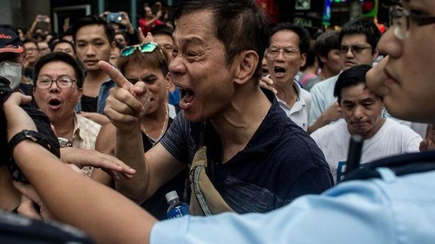 There have been scuffles involving pro-democracy protesters as local residents and pro-Beijing supporters tried to evict them from a street