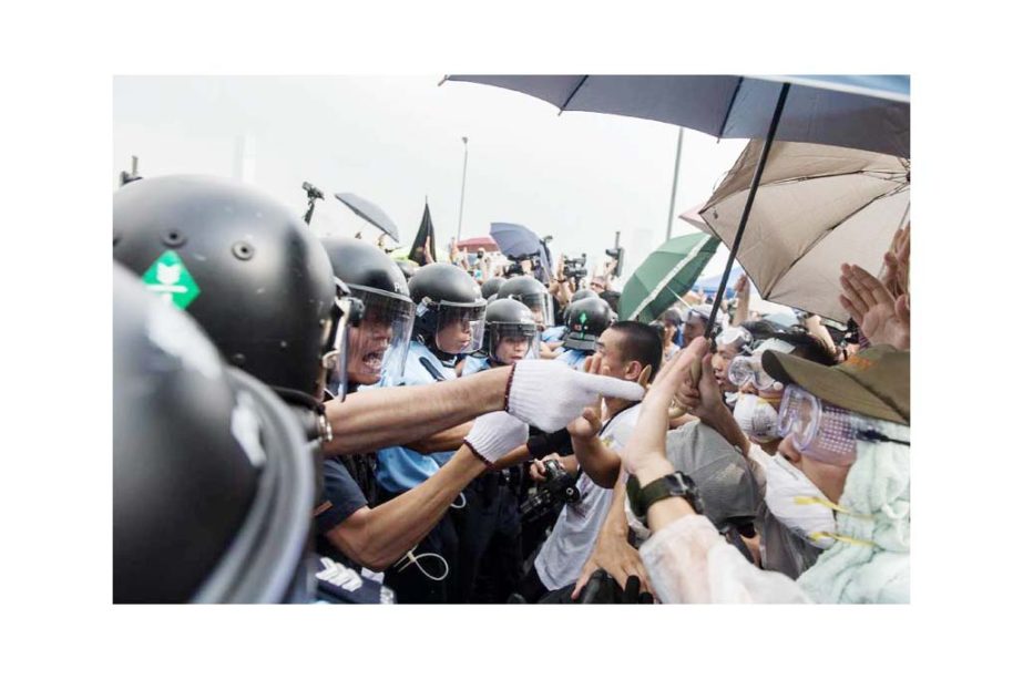 Police and pro-democracy protesters during a scuffle outside government headquarters in Hong Kong on Friday.