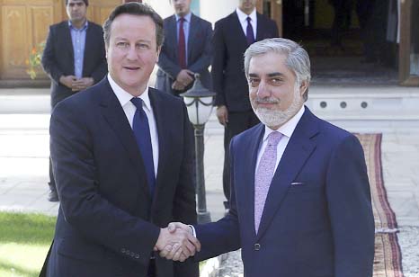 Britain's Prime Minister David Cameron (L) shakes hands with Afghanistan's President Ashraf Ghani after a news conference in Kabul on Friday.