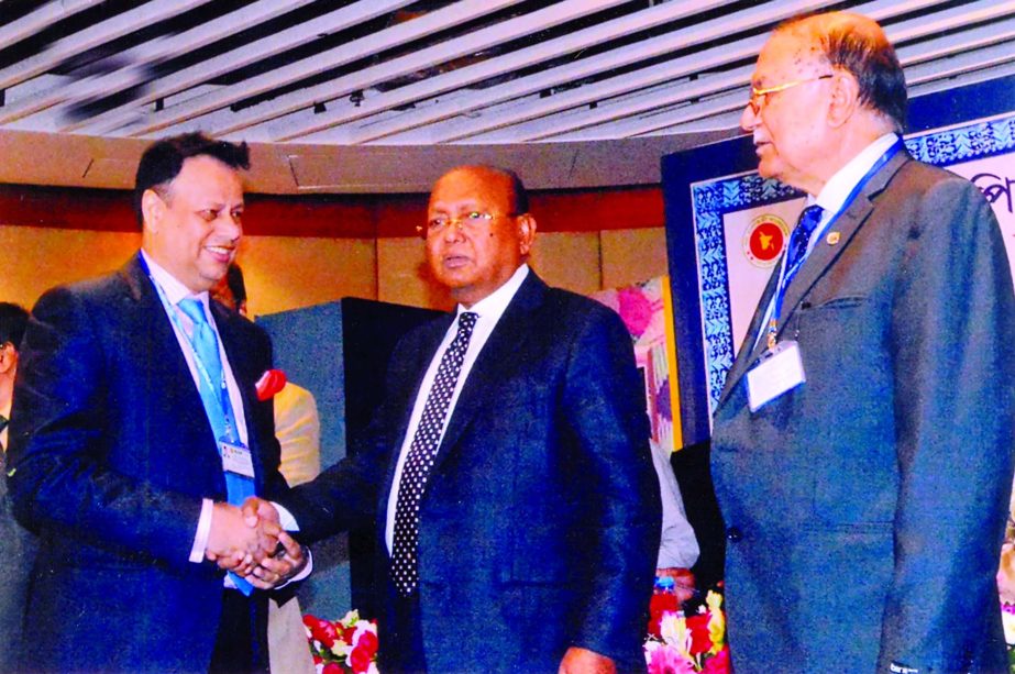 Commerce Minister Tofail Ahmed handing over CIP Card to Md Bazlur Rahman, Director of FBCCI, for his contributions in export business of the country at a city hotel on Wednesday.