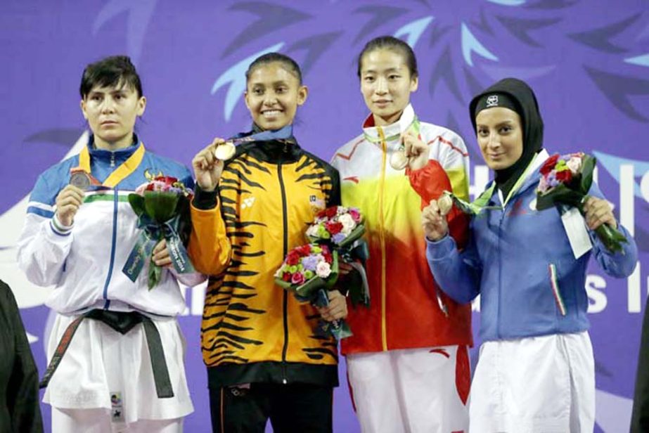Medalists( from left to right): Silver, Barno Mirzaeva of Uzbekistan, gold, Syakilla Salni Binti Jefry Krisnan of Malaysia, and bronze Shin Sujung of China and Fatemeh Chalaki of Iran pose for photographers during the victory ceremony for the Women's -