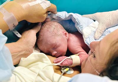 The mother and the baby boy pictured just after his birth. He was born weighing 4lbs after his mother received a womb transplant.