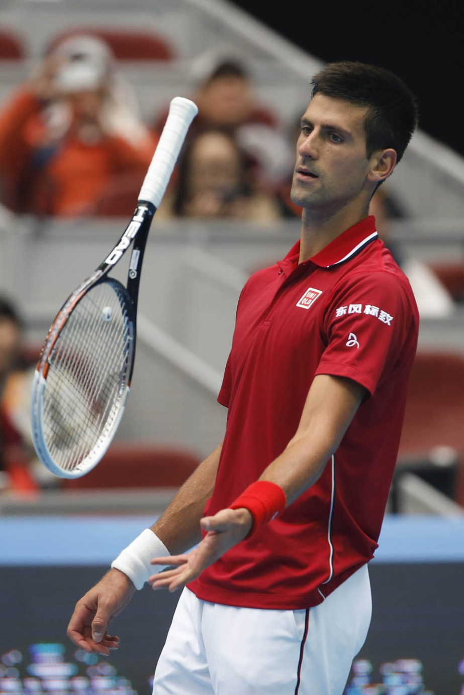 Novak Djokovic of Serbia plays with his racket during his semi final match against Andy Murray of Britain at the China Open tennis tournament at the National Tennis Stadium in Beijing, China on Saturday.