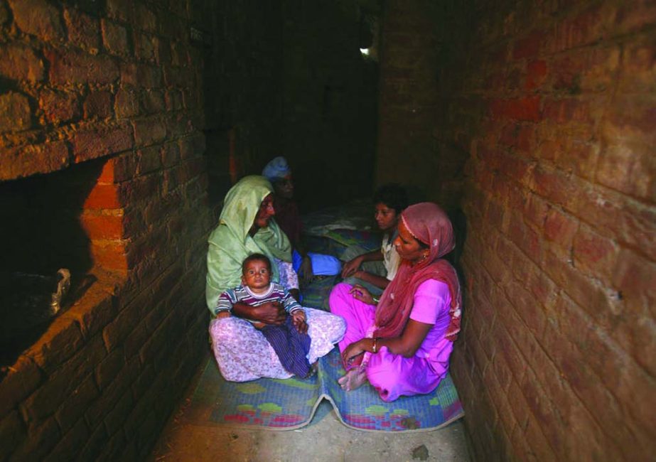 Indian villagers take shelter inside an army bunker at Devi Garh village near Jammu.