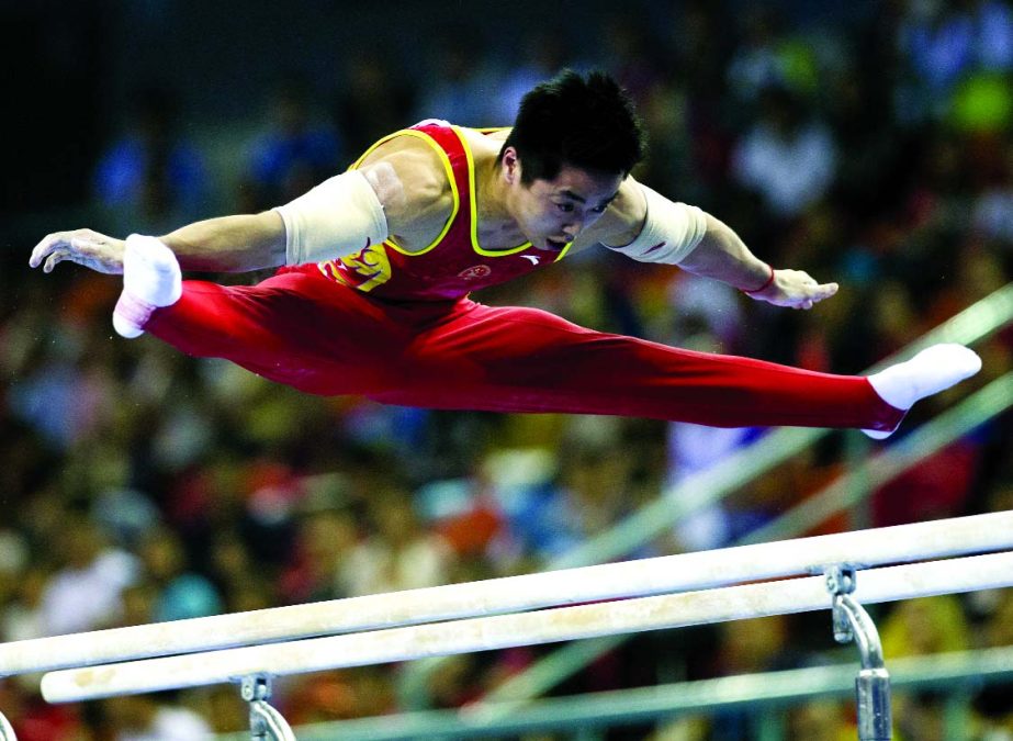 China's You Hao jumps from the parallel bars as he competes in the men's team final of the Artistic Gymnastics World Championship at the Guangxi Gymnasium in Nanning, capital of southwest China's Guangxi Zhuang Autonomous Region on Tuesday.