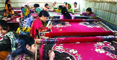 A group of unemployed, poor and distressed rural women conducting needlework at a productoion center in Rangpur to change fortune by earning wages to lead solvent life.