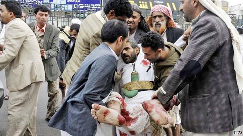 Man carry a man injured in a suicide bomb attack in Yemen's capital, Sanaa on Thursday.