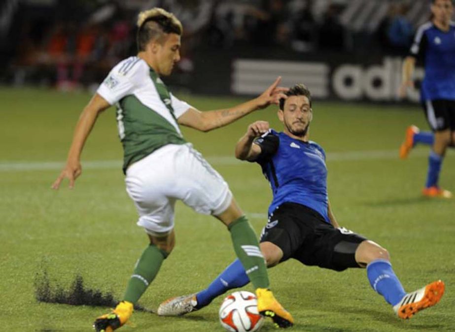 San Jose Earthquakes' Jean-Baptiste Pierazzi (right) defends against Portland Timbers' Maximiliano Urruti (left) during the second half of an MLS Soccer game in Portland, Ore on Wednesday.