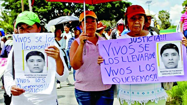 People march along a highway in Chilpancingo, Guerrero state, Mexico Protesters carried photos of the missing students along a highway in Chilpancingo.