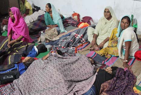 Indian women take shelter at Abdullian village, in Jammu and Kashmir state, India.