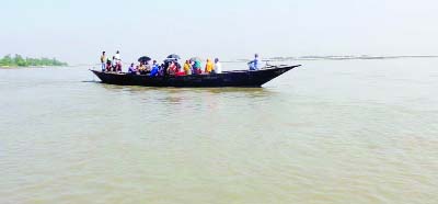 JAMALPUR: Locals crossing Jamuna River risking their lives by a tiny boat at Islampur Uliya Ghat to Fulcxhhori Ghat .This picture was taken on Friday.