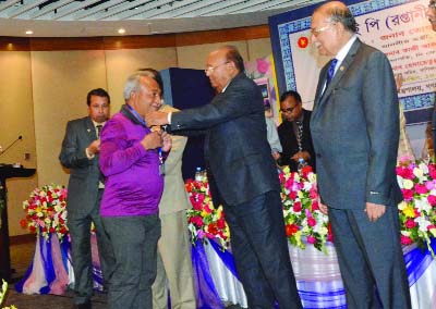 NARSINGDI: Abdul Kader Mollah, founder of Abdul Kader Mollah City College and MD of Ms Aduri Apparels Ltd receiving CIP card from Commerce Minister Tofayel Ahmed for his outstanding contributions in exporting ready made garments (Net) at a function in