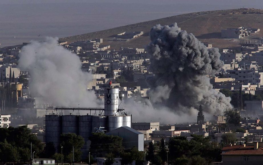 Smoke rises following an airstrike by the US-led coalition aircrafts, during fighting between Syrian Kurds and the militants of Islamic State group, as seen from the outskirts.