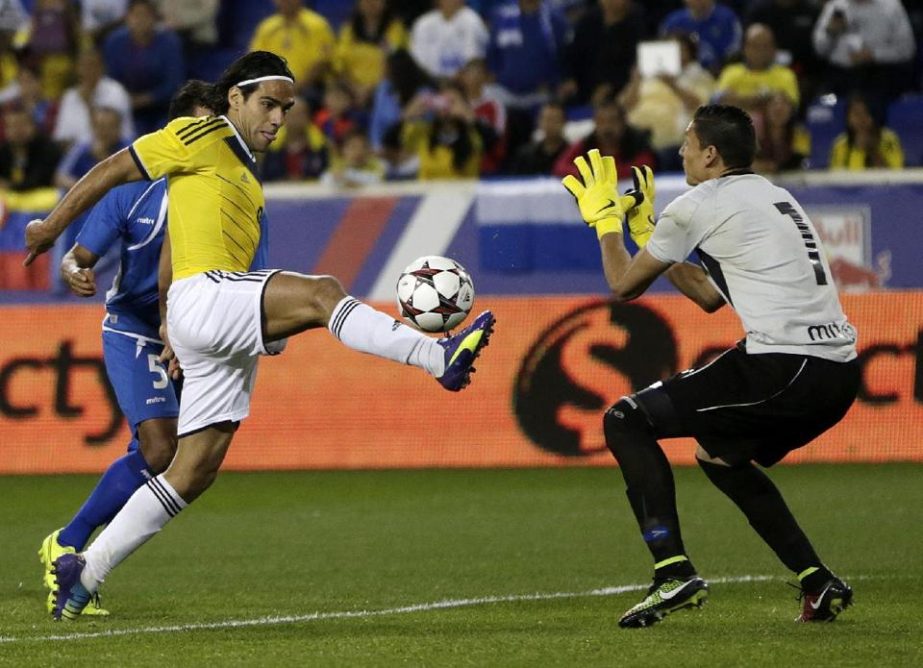 Colombia's Falcao Garcia ( center ) kicks the ball as El Salvador goalkeeper Henry Hernandez (right) and Alexander Mendoza (back) defend during the second half of an international soccer friendly match at Red Bull Arena in New Jersey on Friday.