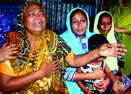 Wailing family members of youth Nasir Hossain who was beaten to death by miscreants for protesting 'teasing' of his sister in Gultek area under Bhasantek in city on Saturday.
