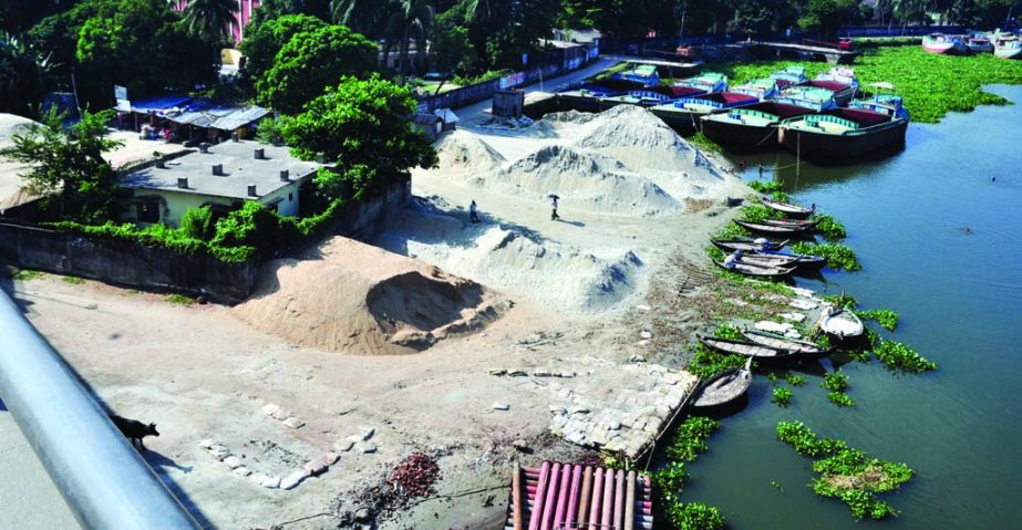 Unholy traders dumping sand occupying Shitalakhya River defying the order of High Court. The snap was taken from under Sultana Kamal Bridge in Demra.