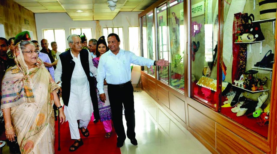 Prime Minister Sheikh Hasina sees various jute products showed at the exhibition board of Jute and Textile Ministry on Sunday while she visited there. BSS photo