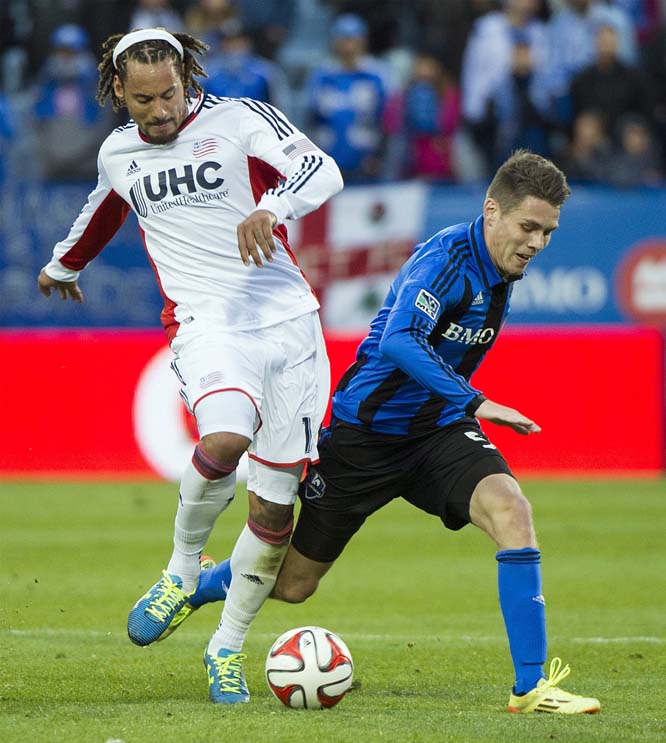 Montreal Impact's Maxim Tissot (right) and New England Revolution's Jermaine Jones battle for the ball during the second half of an MLS soccer game in Montreal on Saturday.