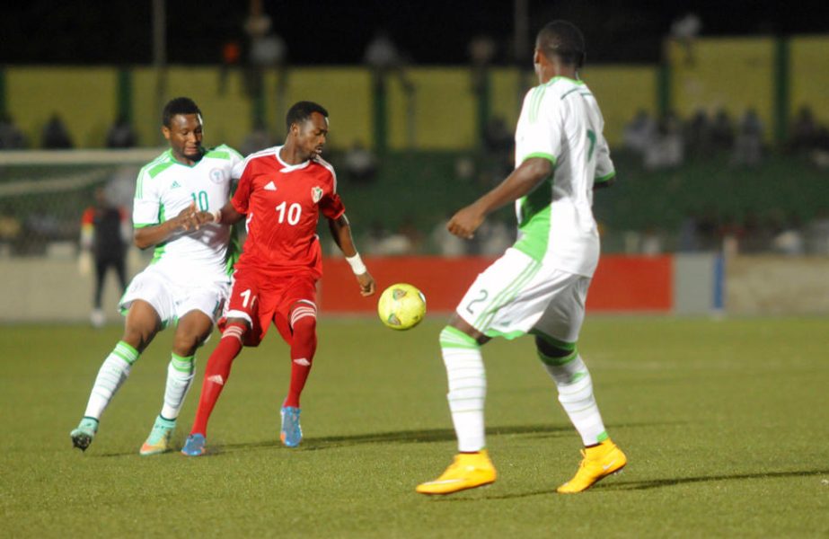 Nigeria's midfielder John Obi Mikel (L) defends against Sudan's Muhammad El Tahir (C) during the 2015 African Cup of Nations qualifying football match in Khartoum on Saturday.
