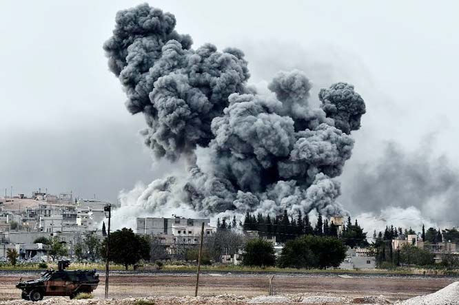 Smoke rises after an air strike on the Syrian town of Kobane, as seen from the Turkish border village of Mursitpinar.